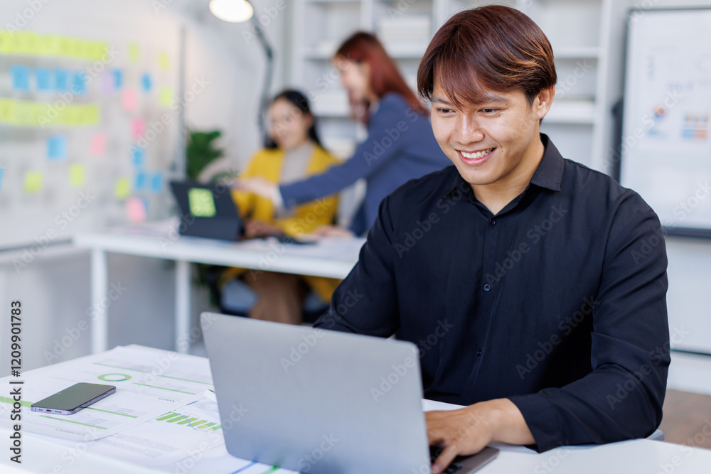 Smiling businessman working on a laptop computer in a modern office,doing finances, accounting analysis, report data pointing graph Freelance education and technology concept. Smiling businessman working on a laptop computer in a modern office,doing finances, accounting analysis, report data pointing graph Freelance education and technology concept.