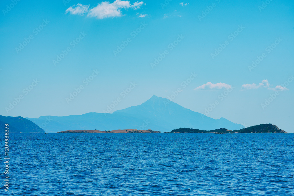 Calm sea, silhouetting distant mountains of Athos ,Greece Calm sea, silhouetting distant mountains of Athos ,Greece