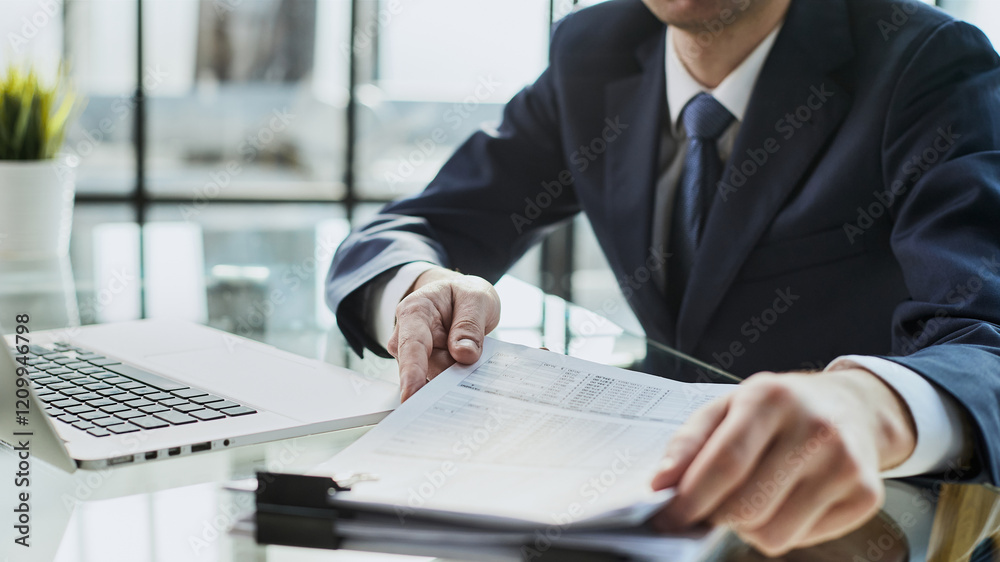 Close-up Of A Businessman Analyzing Financial Report Close-up Of A Businessman Analyzing Financial Report