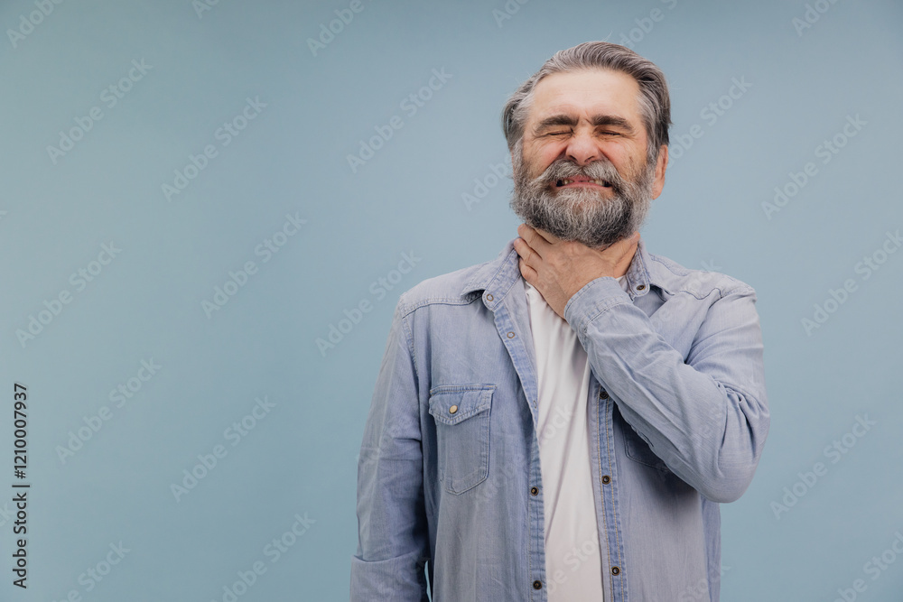 Fototapeta premium Senior man suffering from throat pain is touching his neck