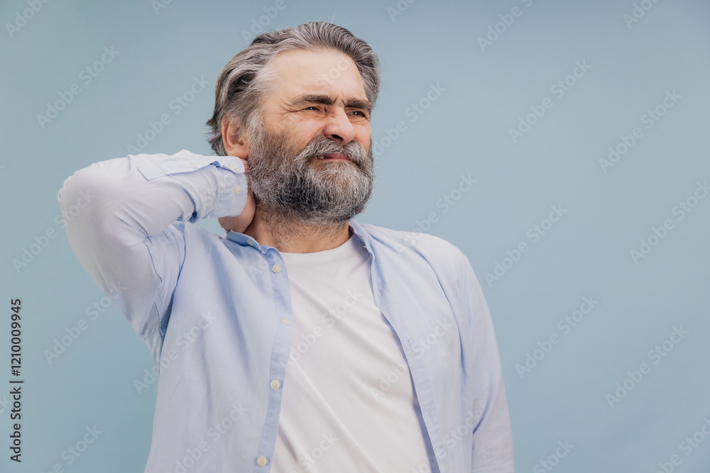 Obraz premium Senior man suffering from neck pain touching his aching body part