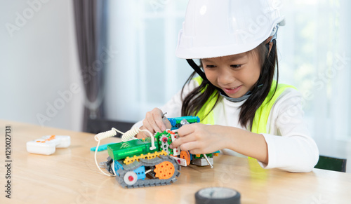 Young girl working on a robot design in Robotics programming class. STEM education using constructor blocks and laptop, Technology educational development for school kids