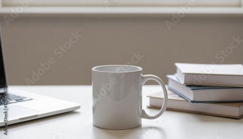 Coffee mug on desk next to books and laptop,  coffee mug on desk mockup