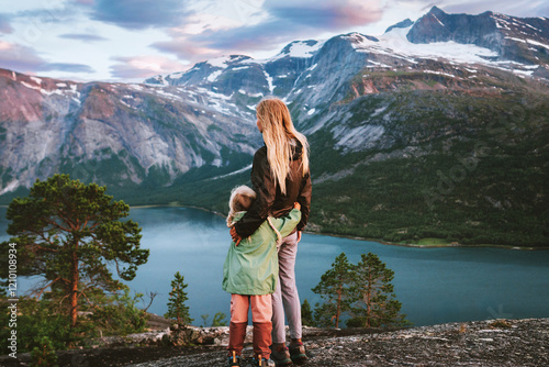 Child and mother walking in mountains hugging family travel in Norway, mom and daughter hiking together active vacations outdoor enjoying landscape, Mothers day holiday photo