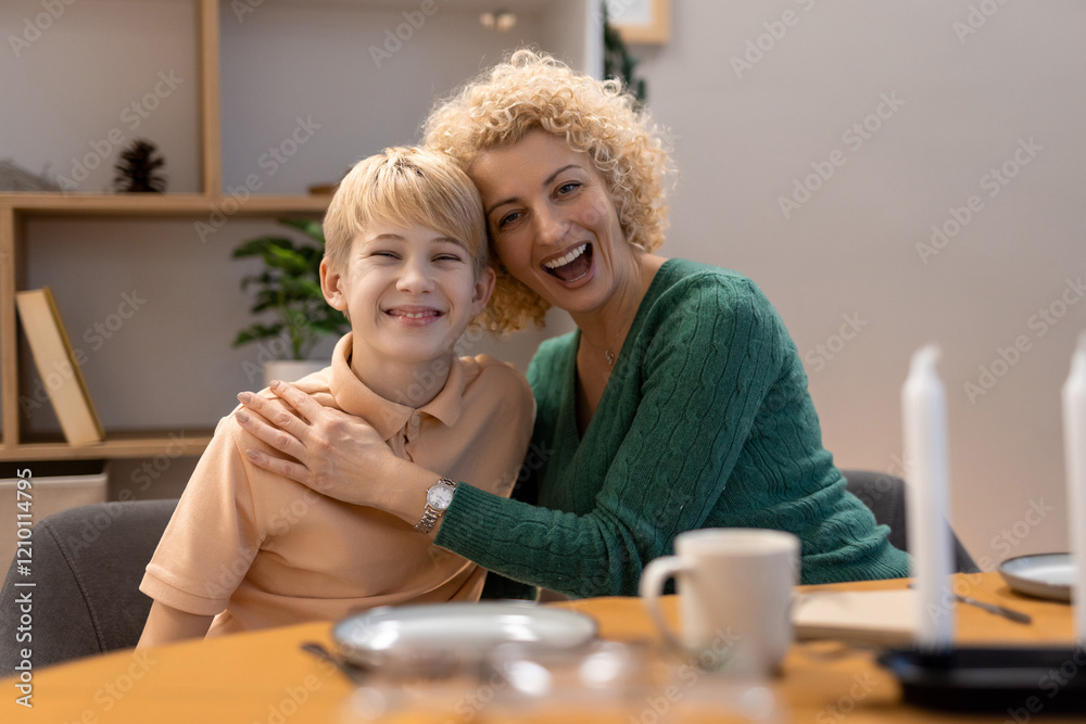 Obraz premium Happy Mother and Son Smiling Together in a Modern Home Setting