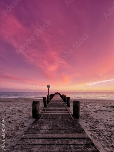 Jetty on North Sea island Föhr in sunset photo