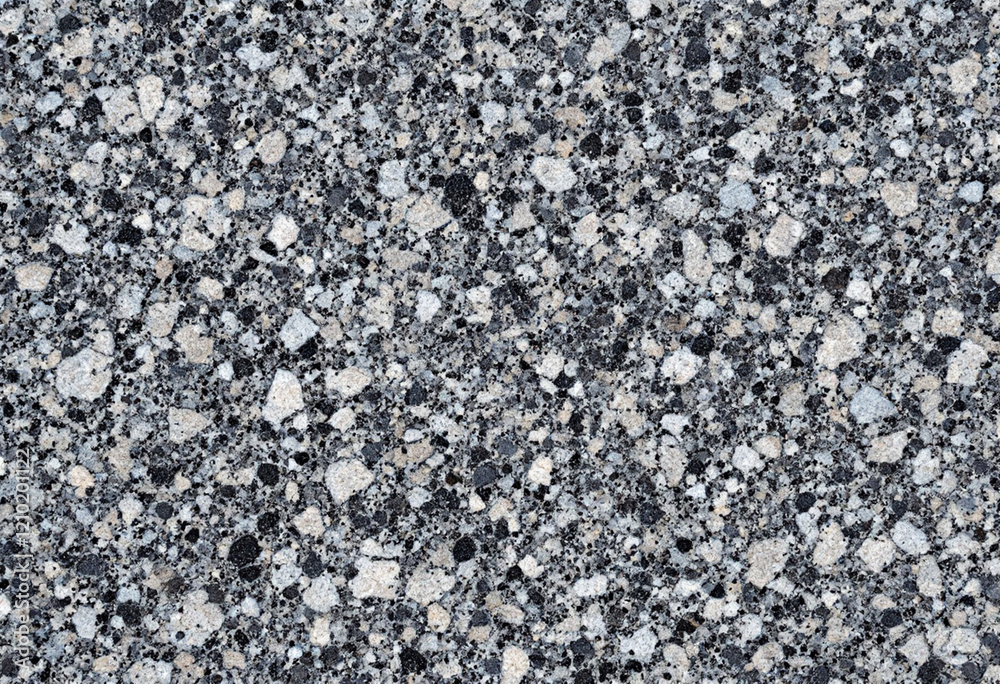 A speckled granite stone texture in shades of black, white, and gray, with a rough, natural finish A speckled granite stone texture in shades of black, white, and gray, with a rough, natural finish