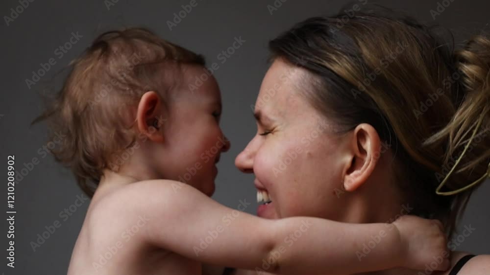 Mom enjoys a warm, affectionate moment with her smiling child at home. communication, hugs and smiles Mom enjoys a warm, affectionate moment with her smiling child at home. communication, hugs and smiles