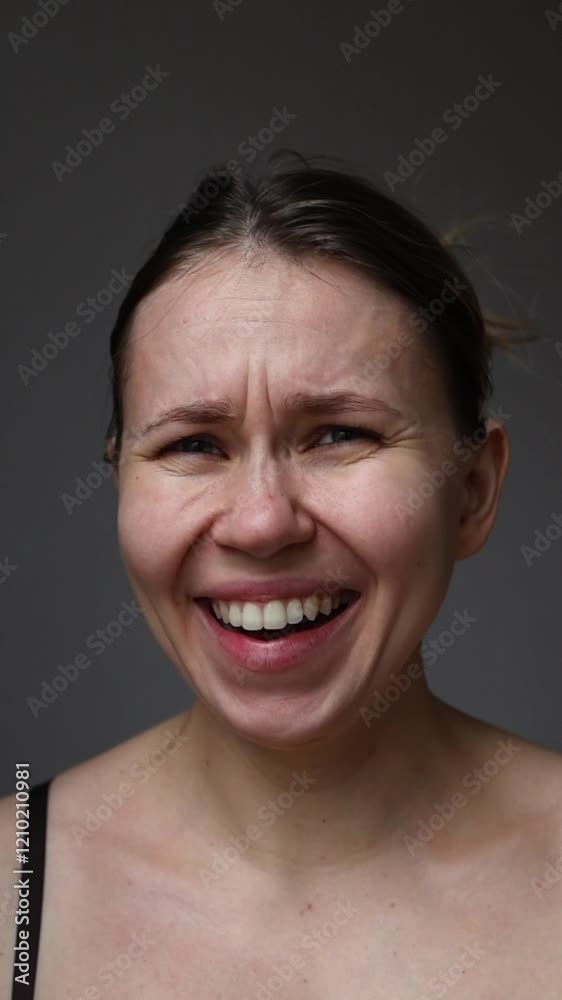 A girl looks at the camera, points at the viewer, laughs, and shakes her head in denial. Emotion: rejection or denial. A girl looks at the camera, points at the viewer, laughs, and shakes her head in denial. Emotion: rejection or denial.