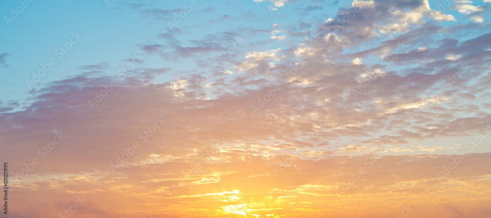 Obraz premium Blue sky at sunrise with clouds in orange color