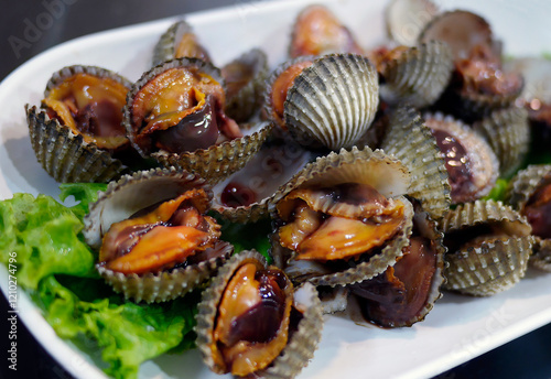 Close up boiled blood Cockles or cockles scalding in a white plate, famous local seafood menu, street food in Thailand