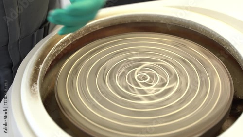 Hands Skillfully Preparing a Material in a Laboratory Setting for Various Scientific Applications
