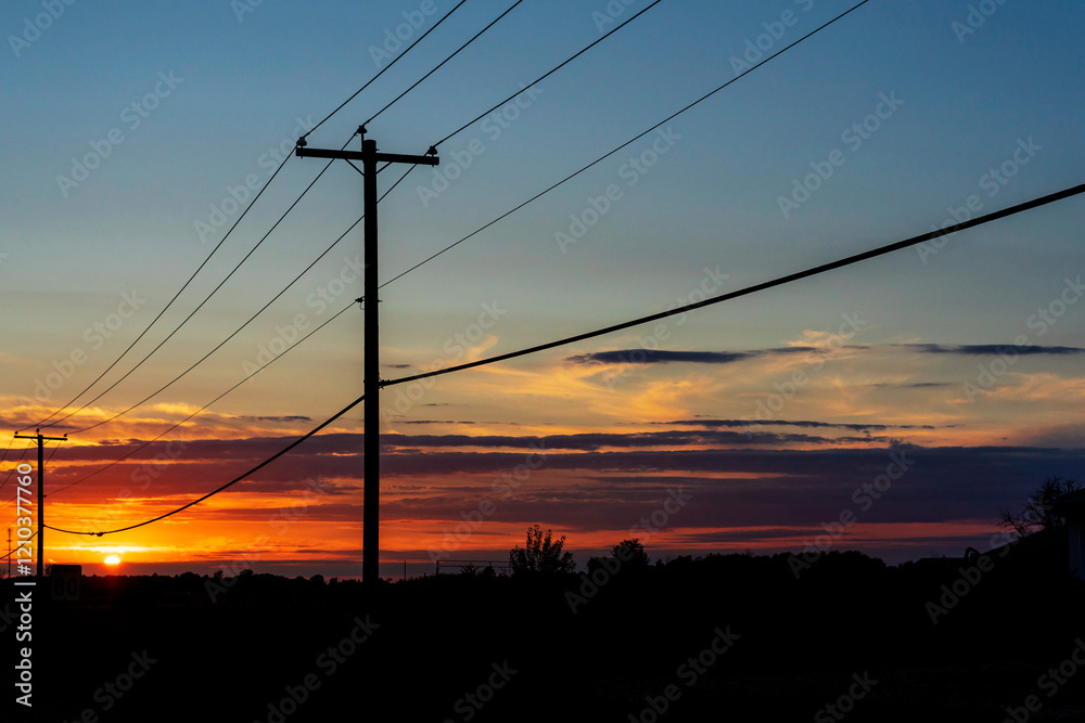 Power transmission line poles against the sky at sunset Power transmission line poles against the sky at sunset