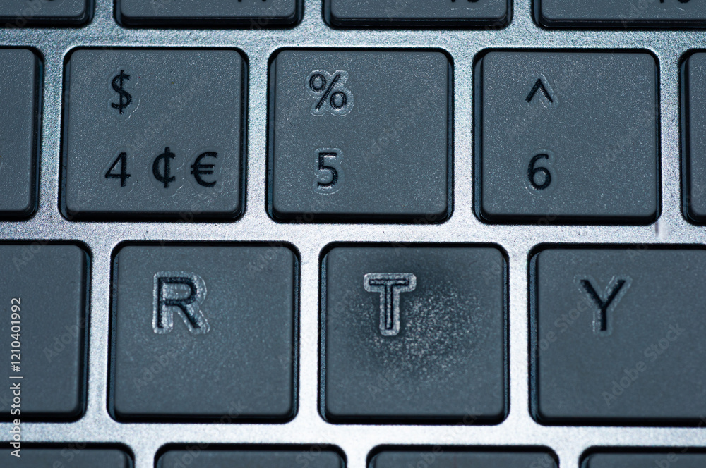 Close-up of a section of a laptop keyboard. The image shows the keys with the dollar sign euro sign (€), percent sign (%), the numbers 4, 5, and 6, and the letters R, T, and Y.  No person is involved