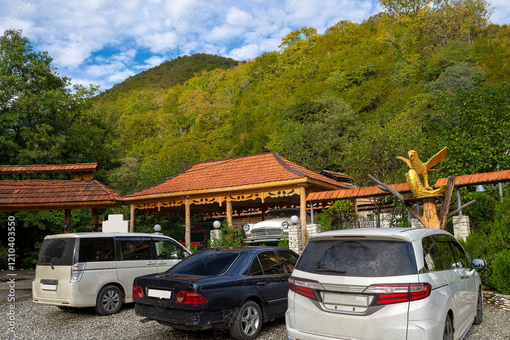 Fototapeta premium Traditional chalet with a rest area and a bar for tourists to visit when climbing a mountain gorge. Foothills of the Caucasus, Abkhazia