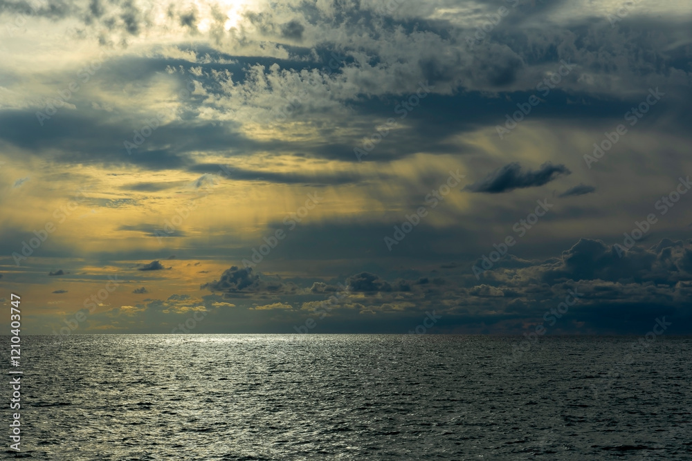 Fototapeta premium Picturesque sunset over the sea with dramatic clouds creating an unusual intriguing image. Black Sea end of summer