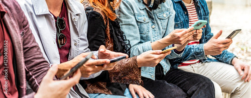 Group of young people using smart mobile phone device outside - Trendy technology concept with guys and girls playing video games app on smartphone