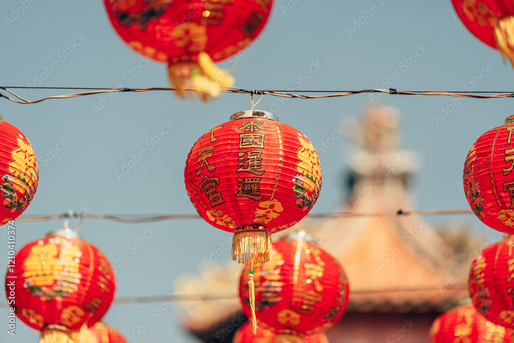 Obraz premium Red Chinese lantern(Translation Hieroglyph text Happy New Year) hanging in a row during day time for Chinese new year celebration.