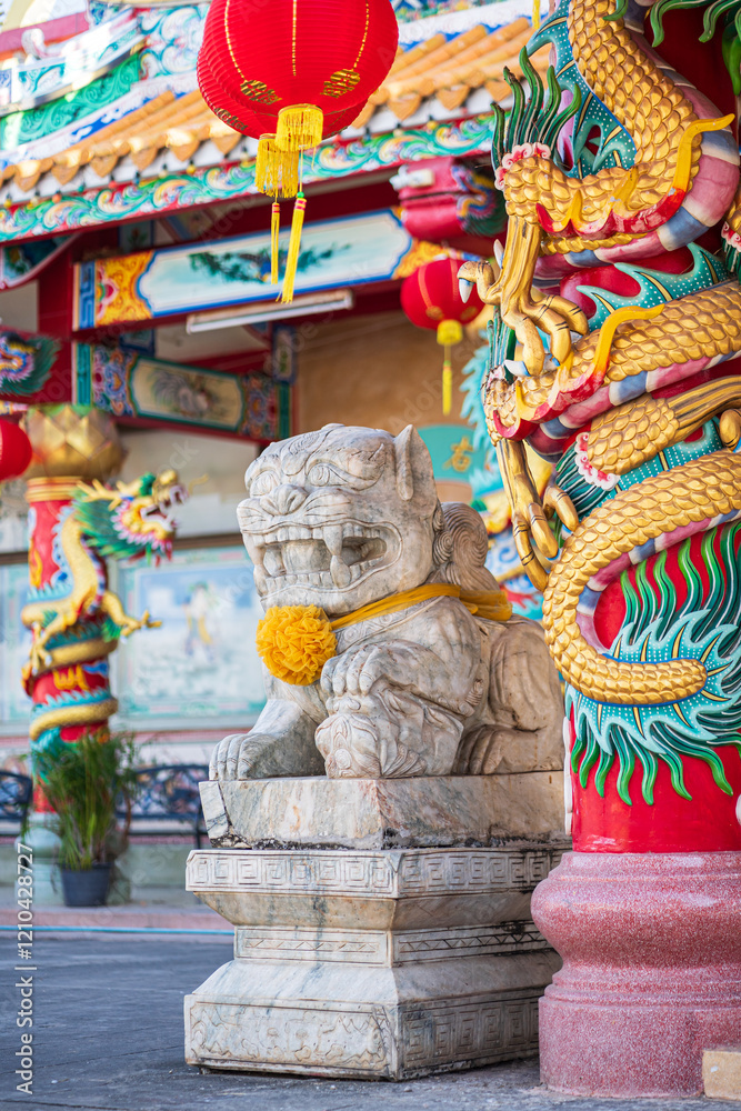 White marble Chinese lion statue in front of Munlanithi Prasatbun Sthan Shrine Is a Chinese shrine Ancient chinese art is the That is a tourist attraction, Phitsanulok Thailand