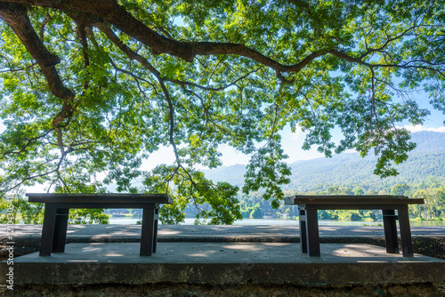 Obraz na płótnie Two chairs empty on green grass at park in nature forest Mountain views spring bright blue sky weather nature abstract clear texture with white clouds summer light sun day. w salonie