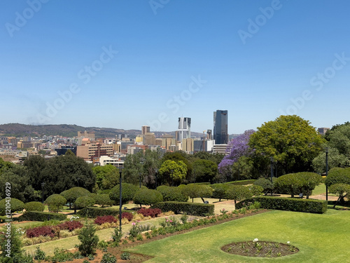 Pretoria city view from Union Buildings gardens, high buildings and blooming jacaranda trees. South Africa.