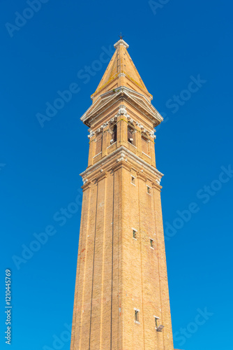 Towering historic bell tower against a radiant blue sky in Burano photo