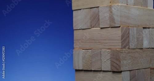 Wood Blocks Stacked Harmoniously Against a Clear Blue Sky Background for Contrast and Depth