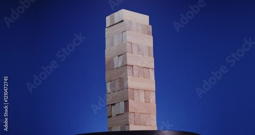A colorful wooden block tower stands against a dramatic blue background, sparking creativity