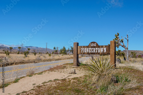 Pioneertown California welcome sign next to a paved road