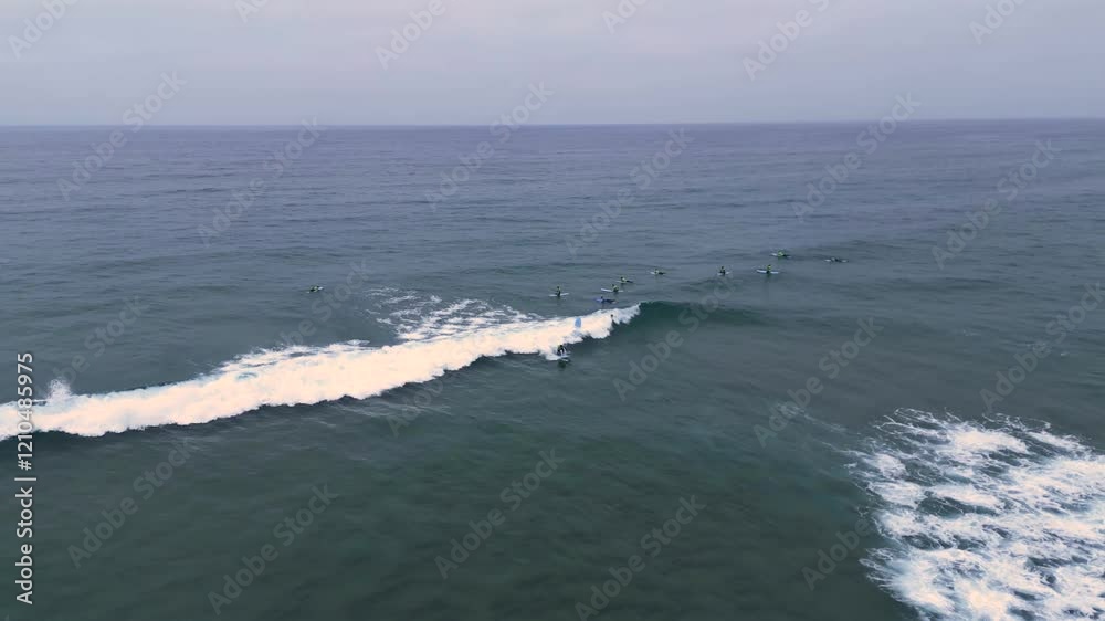 Aerial view of surfers on a wave off the coast of Portugal