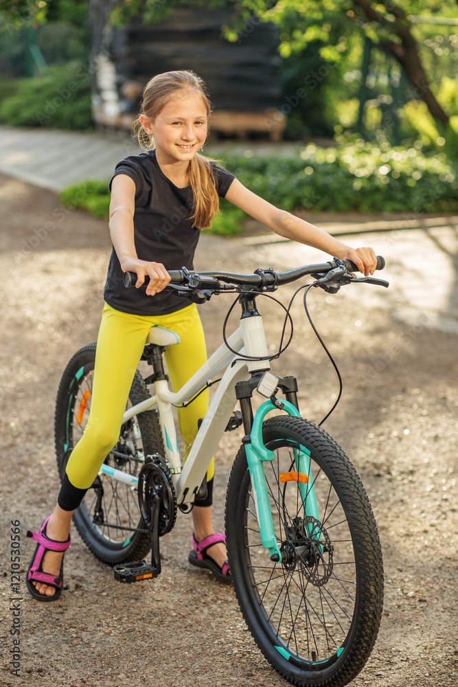 Child enjoying sunny day while riding her bicycle in park Child enjoying sunny day while riding her bicycle in park