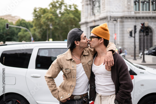 Affectionate colombian gay couple embracing and kissing publicly