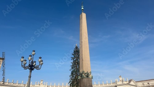 Rome, Italy - 01082025 - The Vatican obelisk is devoid of any Egyptian hieroglyphics, but has on two of its faces a dedication to the Roman emperors Augustus and Tiberius, made by Caligula photo