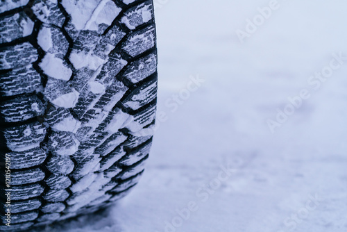 Close-up of a snow-covered tire in Swedish Lapland winter photo