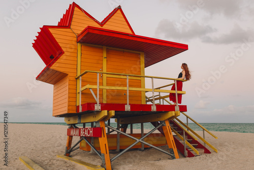 Wallpaper Mural Redhead woman at a Miami Beach lifeguard station at sunset Torontodigital.ca