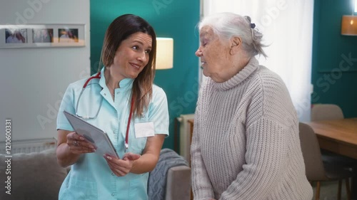 Wallpaper Mural A kind female nurse using a digital tablet talking to a retired grandmother at home during a medical visit Torontodigital.ca