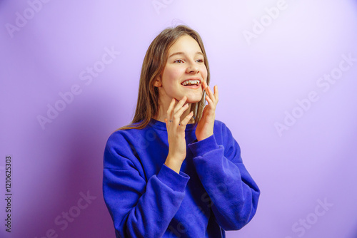 smiling girl with dental plate on purple studio background