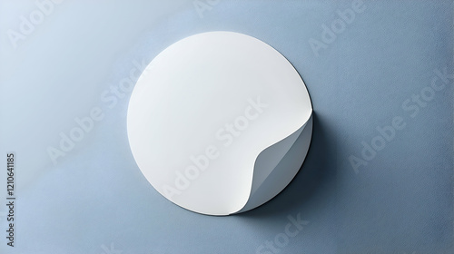 A round sticker mockup with a curled corner, perfect for labels, gift tags, or branding purposes.