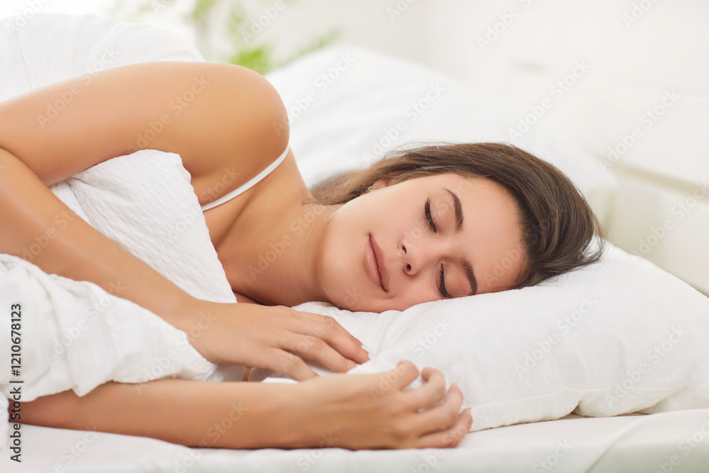 Close up of peaceful relaxed woman sleeping in sweet dreams lying on bed in cozy modern white bedroom in the morning. Healthy young girl napping with comfort resting on pillow at home. Close up of peaceful relaxed woman sleeping in sweet dreams lying on bed in cozy modern white bedroom in the morning. Healthy young girl napping with comfort resting on pillow at home.
