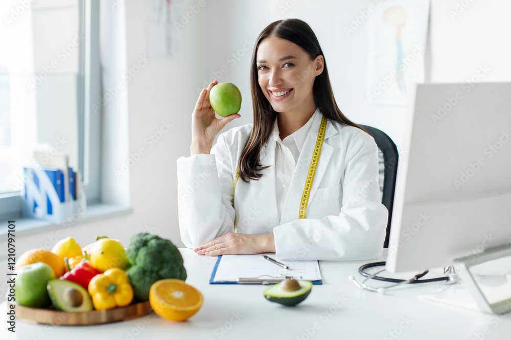 European woman dietitian holding apple, sitting at desk with plate of fruits and vegetables, recommending weight loss clinic, copy space European woman dietitian holding apple, sitting at desk with plate of fruits and vegetables, recommending weight loss clinic, copy space