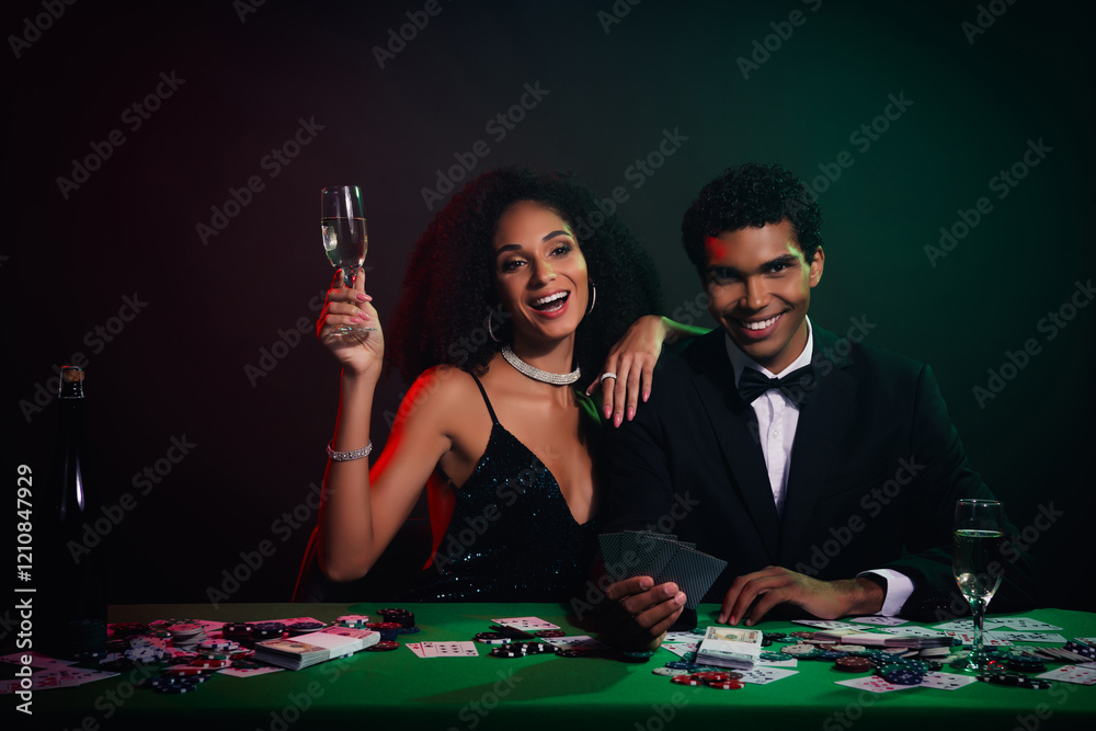 A young couple enjoying a glamorous night out at a casino, celebrating with champagne. A young couple enjoying a glamorous night out at a casino, celebrating with champagne.