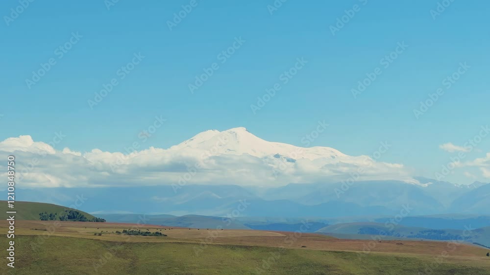 View of Elbrus from the Bermamyt plateau. Caucasus 2023. A trip to Bermamyt, the Grand Canyon in Russia. Mountain landscape on a summer day. Blue sky of Karachay-Cherkessia. Caucasian Ridge 4K View of Elbrus from the Bermamyt plateau. Caucasus 2023. A trip to Bermamyt, the Grand Canyon in Russia. Mountain landscape on a summer day. Blue sky of Karachay-Cherkessia. Caucasian Ridge 4K