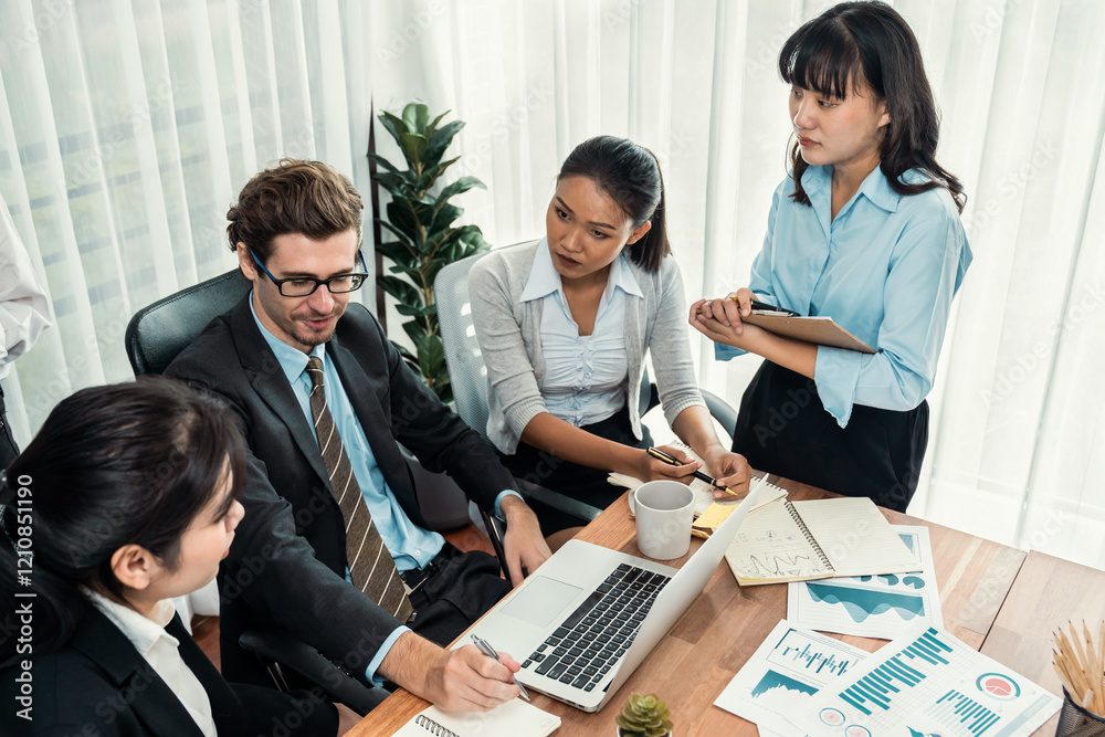Diverse group of business analyst team analyzing financial data report paper on office table. Chart and graph dashboard by business intelligence analysis for strategic marketing planning Meticulous Diverse group of business analyst team analyzing financial data report paper on office table. Chart and graph dashboard by business intelligence analysis for strategic marketing planning Meticulous