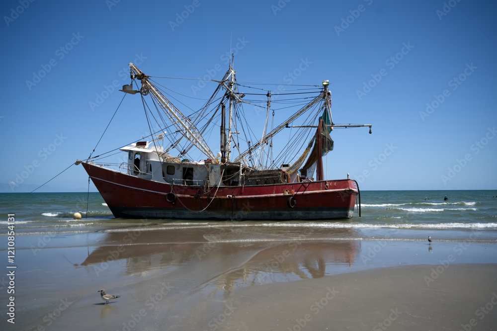 Stranded Fishing Boat on a Sandy Shore Under Clear Blue Skies Stranded Fishing Boat on a Sandy Shore Under Clear Blue Skies