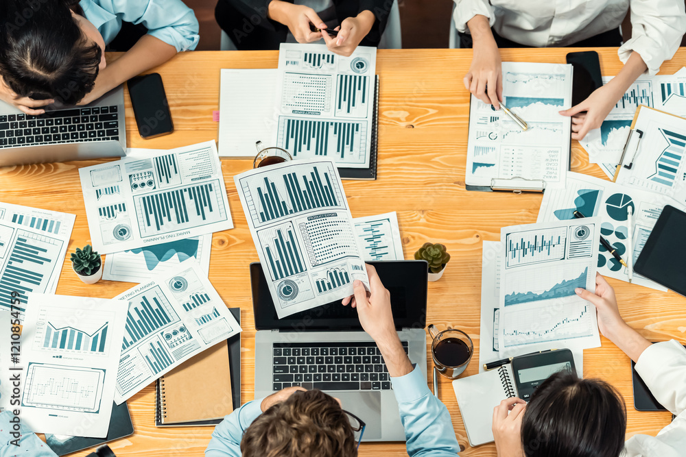 Fototapeta premium Panorama top view diverse group of business analyst team analyzing financial data report paper on meeting table. Chart and graph dashboard by business intelligence analysis. Meticulous