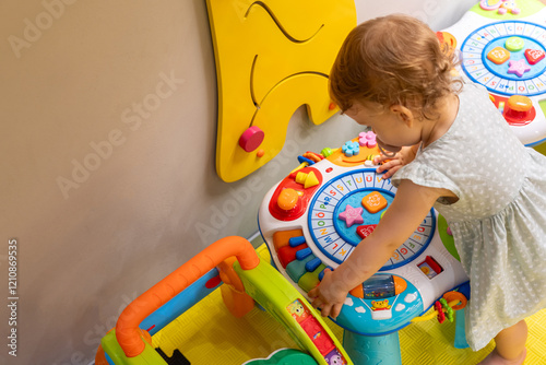 Child learning about shapes and colors using a bright educational toy in a fun playroom. Concept of enhancing creativity and fine motor skills in early childhood photo