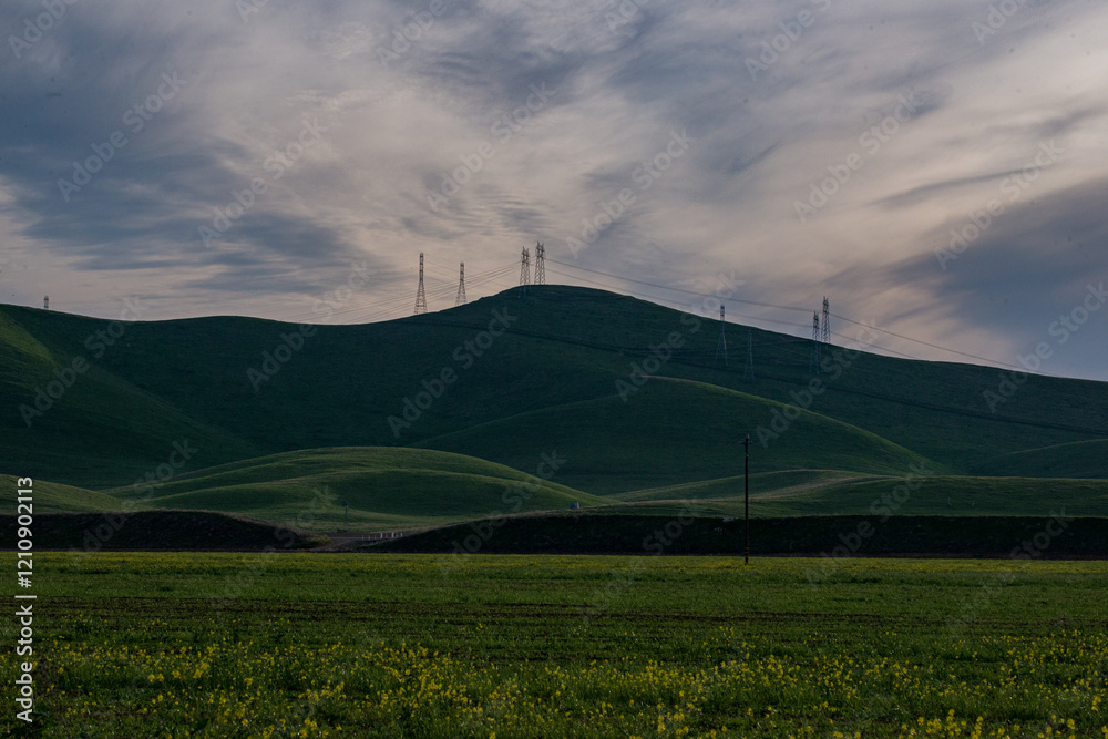 Power lines stretching across fields and mountains of rural central California. Scene from Interstate 5. Power lines stretching across fields and mountains of rural central California. Scene from Interstate 5.