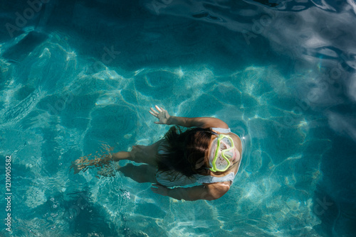 Girl in the pool on a sunny day photo