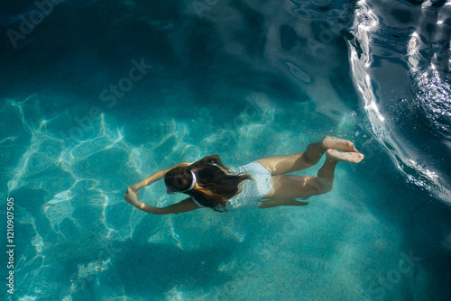 Girl in the pool on a sunny day photo