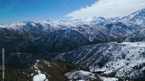 Breathtaking Aerial View of Snow-Draped Mountain Valleys
